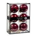 Six glossy deep burgundy glass Christmas ornaments 7 cm diameter, inside a clear rectangular display box with a black frame and a black band label reading 'Goodwill M&G Co. Glass Baubles'.