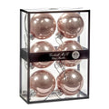 Six rose gold glass Christmas ornaments 7 cm diameter, inside a clear rectangular display box with a black frame and a black band label reading 'Goodwill M&G Co. Glass Baubles'.