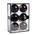 Six shiny silver glass Christmas ornaments 7 cm diameter, inside a clear rectangular display box with a black frame and a black band label reading 'Goodwill M&G Co. Glass Baubles'. Photographed on a white backgrund.