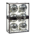 Six shiny silver glass Christmas ornaments 7 cm diameter, inside a clear rectangular display box with a black frame and a black band label reading 'Goodwill M&G Co. Glass Baubles'. Photographed on a white backgrund.