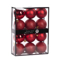 A set of 12 red Christmas ornaments in three finishes (gloss, matte and glitter) 7 cm diameter displayed inside a clear plastic storage box with a black frame and a black band label reading 'Goodwill M&G Co. Shatterproof Baubles'.