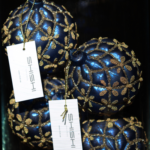 Three metallic blue Christmas ornaments decorated with gold glitter floral patterns, each with a white hanging tag printed with the brand name 'SHISHI'.