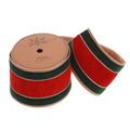 A roll of velvet ribbon with alternating red and dark green stripes, finished with a beige wired edge. A second ribbon strip is shown unrolled from the spool, displaying the texture and color combination.