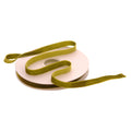 A roll of olive green velvet ribbon spool on a white background.