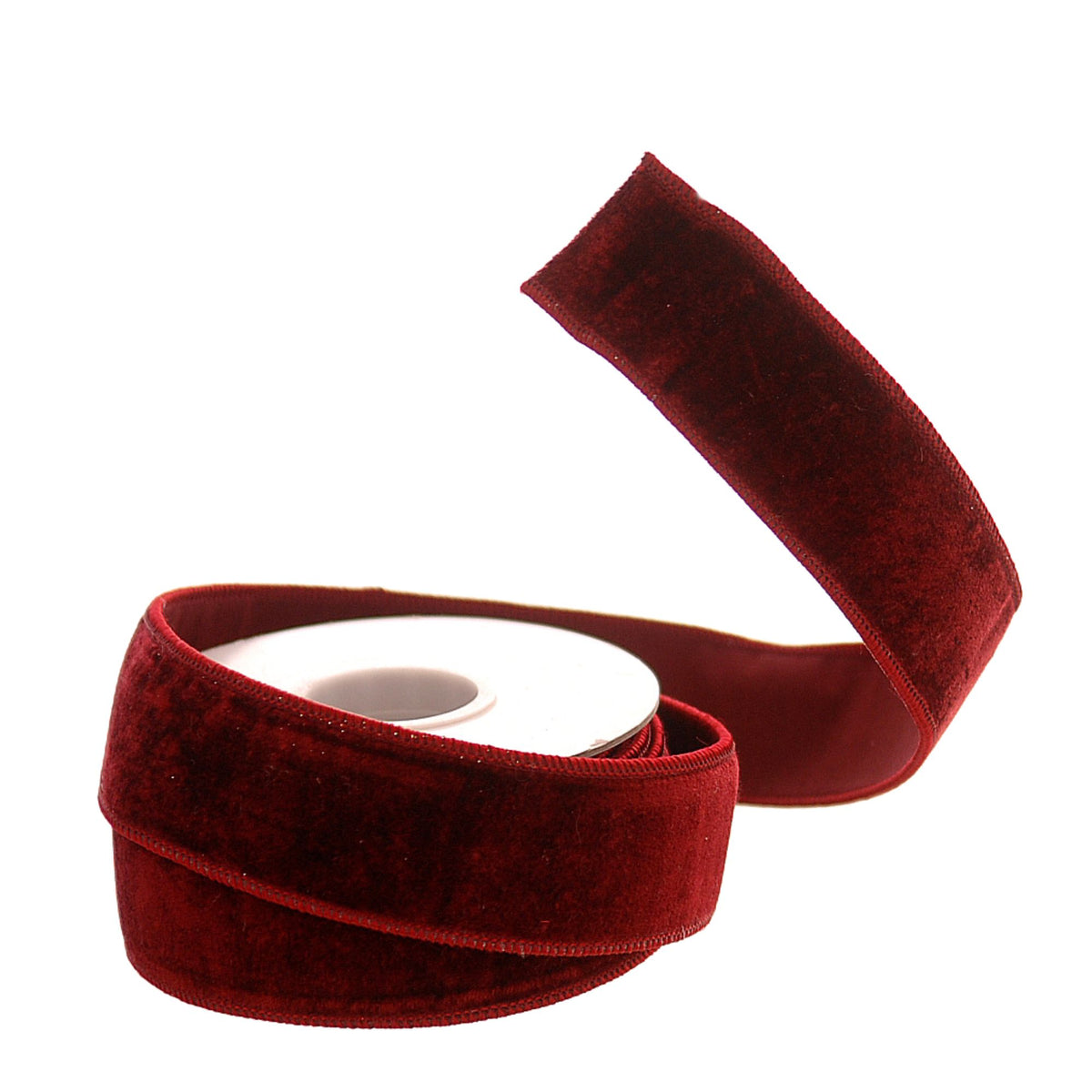 A roll of deep burgundy velvet ribbon, partially unrolled to show its plush texture and flat edge, set against a plain white background.