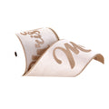 A roll of white satin ribbon with glittery gold cursive text reading 'Merry Christmas, shown on a plain white background.