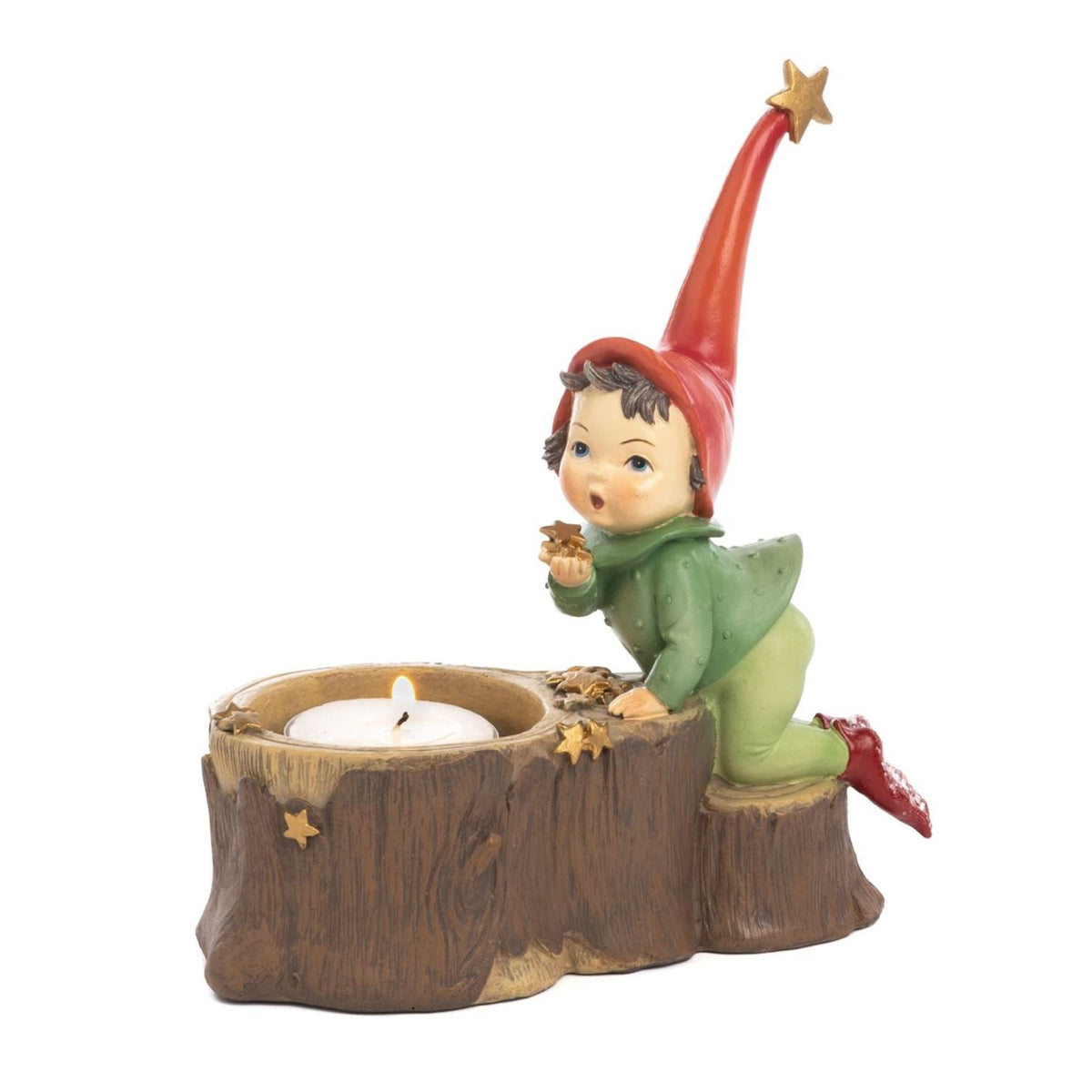 A Christmas helper pixie figurine kneeling beside a tree stump candle holder, wearing a red pointed hat with a gold star, a green outfit, and red shoes, set against a plain white background - 16 cm