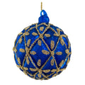A round blue glass Christmas ornament decorated with a gold beaded geometric lattice pattern, featuring a blue hanging loop at the top and a gold hanging string. 