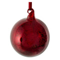 A round, glossy red glass Christmas ornament with a textured, crackled, antique finish and a red hanging ribbon loop at the top, shown against a plain white background.