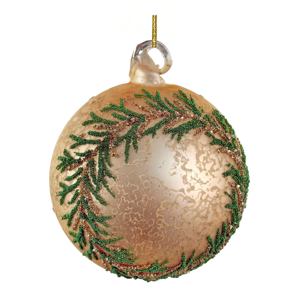 A round glass Christmas ornament with a metallic gold and bronze crackled finish, decorated with green beaded pine branches around the edge, and a gold hanging string at the top, shown on a plain white background.