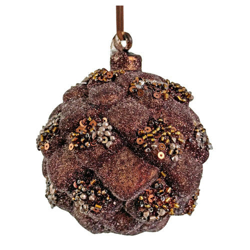 A textured, glittery brown Christmas ornament shaped like a pinecone or acorn, adorned with metallic gold, bronze, and silver sequins, hanging from a brown ribbon against a white background.