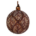 A decorative glass Christmas ornament shaped like a pinecone, featuring a textured metallic bronze and brown leaf pattern with glittery details, complete with a hanging loop at the top, set against a plain white background.